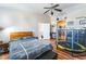 Bedroom featuring wood flooring, a bed, a trampoline and a ceiling fan at 6715 Maple Mesa St, North Las Vegas, NV 89084