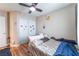 Bedroom with hard floors, ceiling fan, and closet with sliding doors at 6715 Maple Mesa St, North Las Vegas, NV 89084