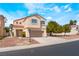 Charming two-story home with red tile roof and neutral stucco exterior, showcasing a well-maintained front yard at 6715 Maple Mesa St, North Las Vegas, NV 89084