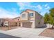 Side exterior view of a charming two-story home with neutral stucco and a red tile roof, spacious driveway at 6715 Maple Mesa St, North Las Vegas, NV 89084
