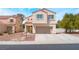 Charming two-story home with red tile roof and neutral stucco exterior, showcasing a well-maintained front yard at 6715 Maple Mesa St, North Las Vegas, NV 89084