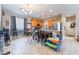 Well-lit kitchen and dining area with stainless steel appliances and tile flooring at 6715 Maple Mesa St, North Las Vegas, NV 89084