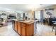 Kitchen island with granite countertops, sink, and stainless steel dishwasher in large living space at 6715 Maple Mesa St, North Las Vegas, NV 89084