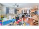 Spacious living room with hardwood floors, ceiling fan and view into kitchen at 6715 Maple Mesa St, North Las Vegas, NV 89084