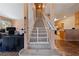 Entryway with carpeted stairs, wood flooring, and views to kitchen and living room at 675 Harbor Mist Ave, Henderson, NV 89015
