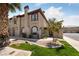 Two-story townhome with tile roof, desert landscaping, and a two-car garage in a gated community at 675 Harbor Mist Ave, Henderson, NV 89015