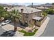 Two-story townhome with tile roof, desert landscaping, and a two-car driveway in a gated community at 675 Harbor Mist Ave, Henderson, NV 89015