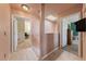 Well-lit hallway with neutral colored walls and views into other rooms, offering a sense of space at 675 Harbor Mist Ave, Henderson, NV 89015