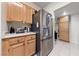 The Kitchen has stainless steel refrigerator, light wood cabinets and tile floor at 675 Harbor Mist Ave, Henderson, NV 89015