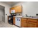 The Kitchen has wooden cabinets, appliances and leads to a laundry area at 675 Harbor Mist Ave, Henderson, NV 89015