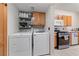 Spacious laundry room featuring washer, dryer, cabinets, and counter space at 675 Harbor Mist Ave, Henderson, NV 89015