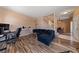 Living room with wood floors, staircase, dining area, and view to exterior at 675 Harbor Mist Ave, Henderson, NV 89015
