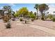 Picnic table in community park with desert landscaping and mature trees at 675 Harbor Mist Ave, Henderson, NV 89015