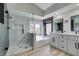 Modern bathroom with a glass shower, soaking tub, and dual sink vanity at 71 Sea Holly Way, Henderson, NV 89074
