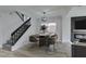 Modern dining room featuring a round table, chairs, and nearby staircase at 71 Sea Holly Way, Henderson, NV 89074