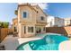 The backyard features a private pool next to the house under a sunny blue sky at 71 Sea Holly Way, Henderson, NV 89074