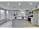 Spacious, updated kitchen with white cabinets, island, and stainless-steel appliances at 71 Sea Holly Way, Henderson, NV 89074