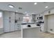 Well-lit kitchen with gray cabinets, quartz countertops, island, and stainless steel appliances at 71 Sea Holly Way, Henderson, NV 89074