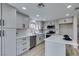A bright kitchen featuring stainless steel appliances, gray cabinets and hardware, and quartz countertops at 71 Sea Holly Way, Henderson, NV 89074