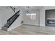 Living room with staircase, fireplace, and modern floors, bathed in natural light at 71 Sea Holly Way, Henderson, NV 89074