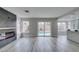 An open-concept living area showcasing a sleek fireplace, wood-look floors and access to the backyard pool at 71 Sea Holly Way, Henderson, NV 89074