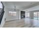 Living room featuring fireplace, modern floors, and ample natural light from large windows at 71 Sea Holly Way, Henderson, NV 89074