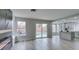 This living room features wood-look flooring, a modern fireplace, and access to the kitchen and backyard pool at 71 Sea Holly Way, Henderson, NV 89074