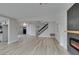 Spacious living room with modern fireplace and stylish lighting, seamlessly connected to other living areas at 71 Sea Holly Way, Henderson, NV 89074