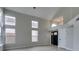 Bright and airy living room with high ceilings and large windows and tile floors at 71 Sea Holly Way, Henderson, NV 89074