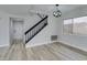 Living room with modern floors, staircase, and front door at 71 Sea Holly Way, Henderson, NV 89074