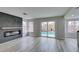 Open-concept living room featuring a modern fireplace and sliding glass doors with a view of the pool at 71 Sea Holly Way, Henderson, NV 89074