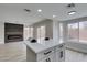 A living room and kitchen area with hardwood-style floors, modern fireplace and fixtures at 71 Sea Holly Way, Henderson, NV 89074