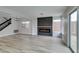 Spacious living room with modern fireplace, stylish lighting, and staircase leading to the upper level at 71 Sea Holly Way, Henderson, NV 89074