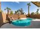 A beautiful backyard pool is surrounded by lush landscaping and towering palm trees at 71 Sea Holly Way, Henderson, NV 89074