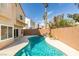 A backyard pool with landscaping is visible from the covered patio and rear windows at 71 Sea Holly Way, Henderson, NV 89074