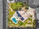A captivating aerial view of the home features a sparkling pool, solar panels, and lush landscaping at 7300 Breezy Night Ct, Las Vegas, NV 89129