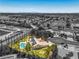An aerial view of the home featuring a backyard pool, solar panels and lush landscaping in a lovely community at 7300 Breezy Night Ct, Las Vegas, NV 89129
