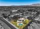 An aerial perspective highlights a home with a pool and solar panels, set in a desert landscape at 7300 Breezy Night Ct, Las Vegas, NV 89129