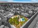 An aerial perspective shows a home with pool and solar panels, nestled in a desert community at 7300 Breezy Night Ct, Las Vegas, NV 89129