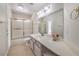 Bathroom with a vanity, a large mirror and a shower-tub combo perfect for relaxation at 7300 Breezy Night Ct, Las Vegas, NV 89129