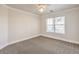 Bedroom featuring neutral walls, carpet flooring, ceiling fan, and a large window with lots of natural light at 7300 Breezy Night Ct, Las Vegas, NV 89129