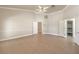Spacious bedroom featuring vaulted ceilings, a ceiling fan and tile flooring, with direct access to a large walk-in closet at 7300 Breezy Night Ct, Las Vegas, NV 89129