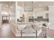 Well-appointed kitchen featuring white cabinetry, stainless steel appliances, and bar seating for casual dining at 7300 Breezy Night Ct, Las Vegas, NV 89129