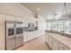 Modern kitchen featuring stainless steel appliances, white cabinets and a breakfast bar with backyard views at 7300 Breezy Night Ct, Las Vegas, NV 89129