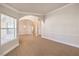 Bright and airy living room featuring arched doorways, decorative lighting, and neutral paint palette at 7300 Breezy Night Ct, Las Vegas, NV 89129