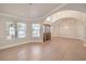 Spacious living room boasting a large window and arched doorways with elegant tile flooring at 7300 Breezy Night Ct, Las Vegas, NV 89129