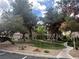 Exterior view of the community common grounds with grass, trees, walking path, and complex at 75 N Valle Verde Dr # 625, Henderson, NV 89074