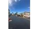 Exterior view of community streets, buildings, and landscaping on a sunny day with blue sky at 75 N Valle Verde Dr # 625, Henderson, NV 89074