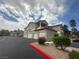 Exterior of multi-story condo building with attached garages, red rock landscaping, and mature palm trees at 75 N Valle Verde Dr # 625, Henderson, NV 89074