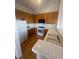 Classic kitchen with wood cabinets, white appliances, breakfast bar, and tile countertops at 75 N Valle Verde Dr # 625, Henderson, NV 89074